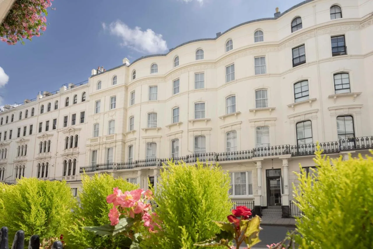 a large white building with trees in front of it at The 55 by Le Mirage in London